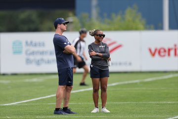 Maya Ana Callender on the field with the New England Patriots.