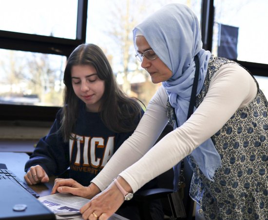 Physics Professor Hava Turkakin works with a student at the computer.