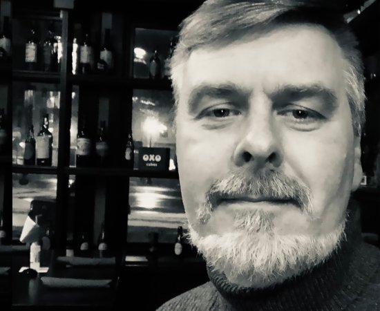 Black and white image of Professor Jeff Miller looking at the camera