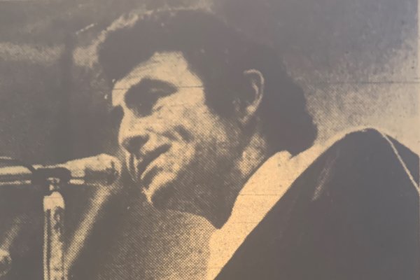 Legendary writer Rod Serling behind a microphone as he addresses the Utica Class of 1973.