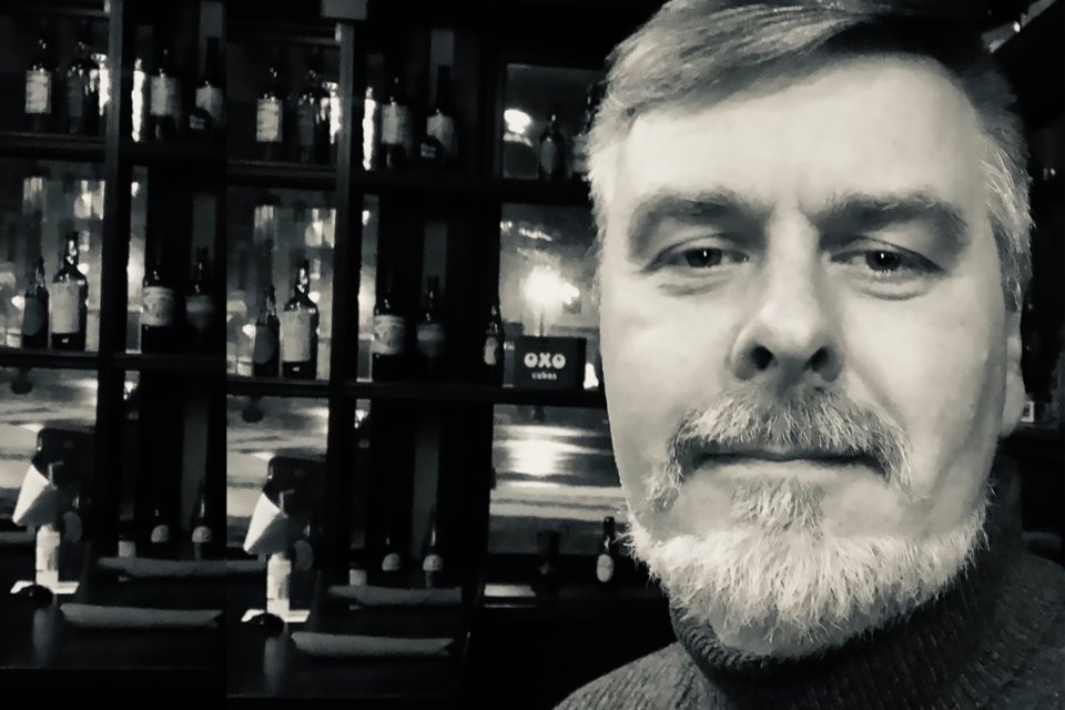 Black and white image of Professor Jeff Miller looking at the camera